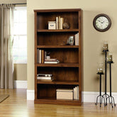 A wooden bookcase displaying an assortment of books alongside decorative objects, creating an inviting reading space.